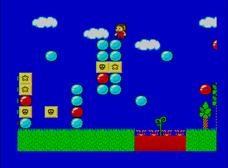 Captura del videojuego Alex Kidd in Miracle World. En ella vemos al protagonista en la parte más alta de una columna formada por bolas de colores y bloques amarillos. En la parte inferior hay un lago de lava del que brota una planta. Por el resto de la pantalla hay repartidos más bloques y bolas.