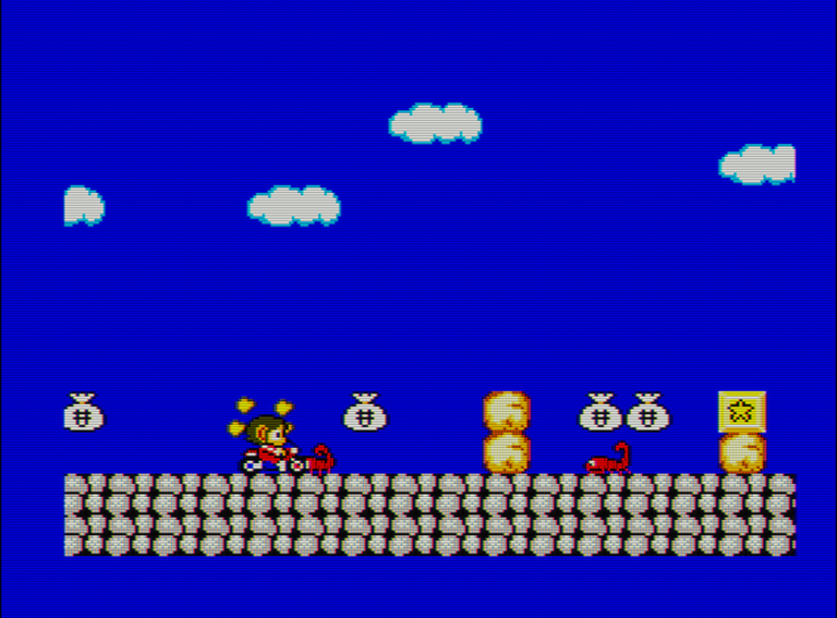 Captura del videojuego Alex Kidd in Miracle World. En ella vemos al protagonista sobre una moto rompiendo un bloque de piedra. En la pantalla hay varias bolsas de dinero, otros bloques y un escorpión que hace de enemigo.