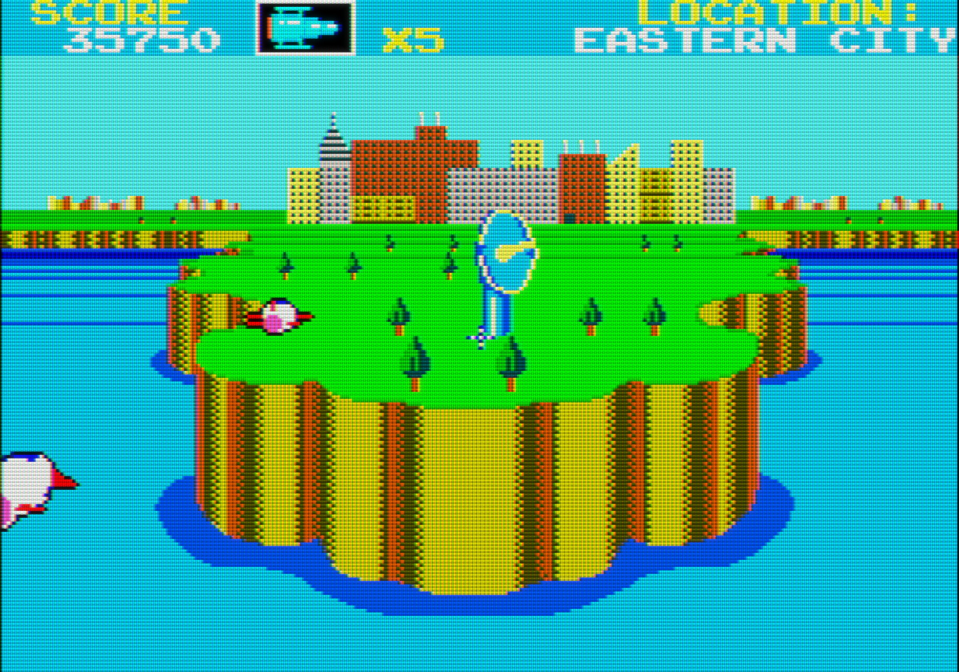 Vemos desde el mar un acantilado. Sobre él hay una gigantesca antena parabólica. Al fondo se ve una ciudad. Por la parte izquierda dos misiles vuelan en dirección a la ciudad.